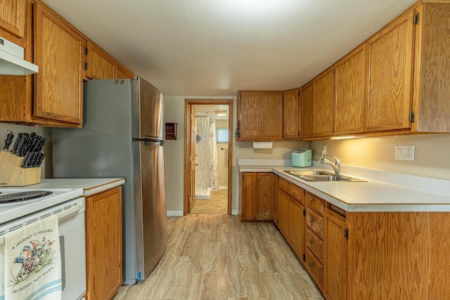 304 Mitchell St, Belleville, WI 53508 - kitchen featuring light wood-style floors, light countertops, under cabinet range hood, a sink, and white electric stove