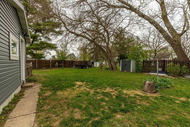 304 Mitchell St, Belleville, WI 53508 - view of yard with a fenced backyard, an outdoor structure, and a shed