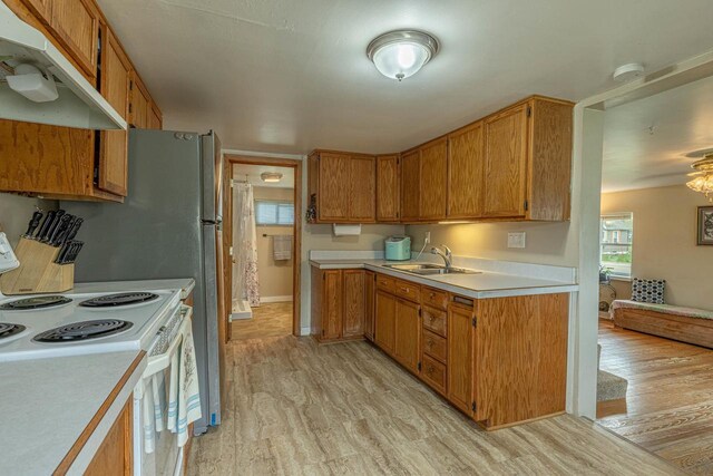 304 Mitchell St, Belleville, WI 53508 - kitchen featuring a sink, light countertops, white electric range oven, and under cabinet range hood