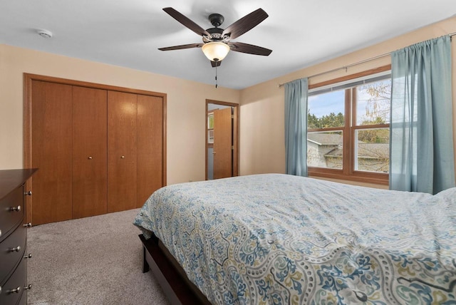 carpeted bedroom featuring a closet and a ceiling fan