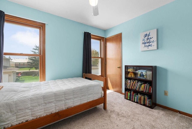 carpeted bedroom with baseboards and ceiling fan