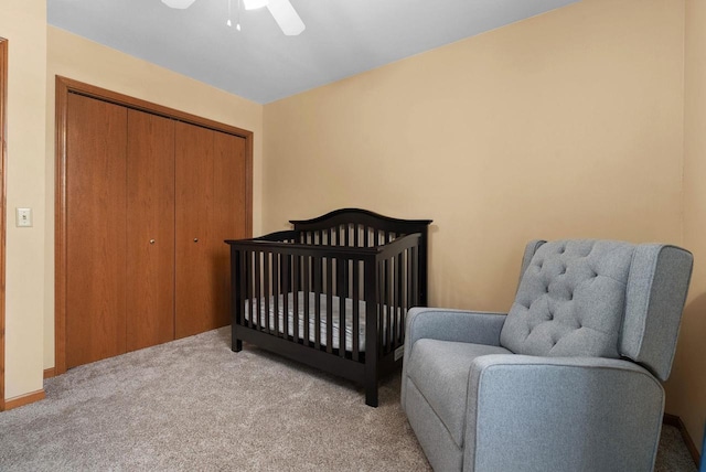 carpeted bedroom featuring a closet and a ceiling fan