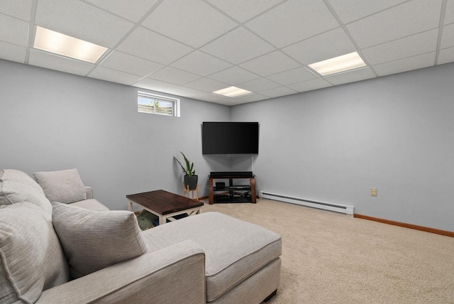 carpeted living area with a paneled ceiling, baseboards, and baseboard heating