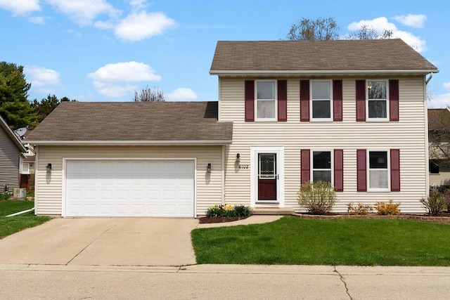 colonial inspired home featuring a garage, driveway, and a front lawn