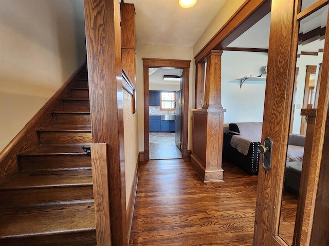 corridor with stairs and wood finished floors