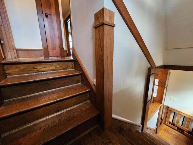 stairs featuring wood finished floors