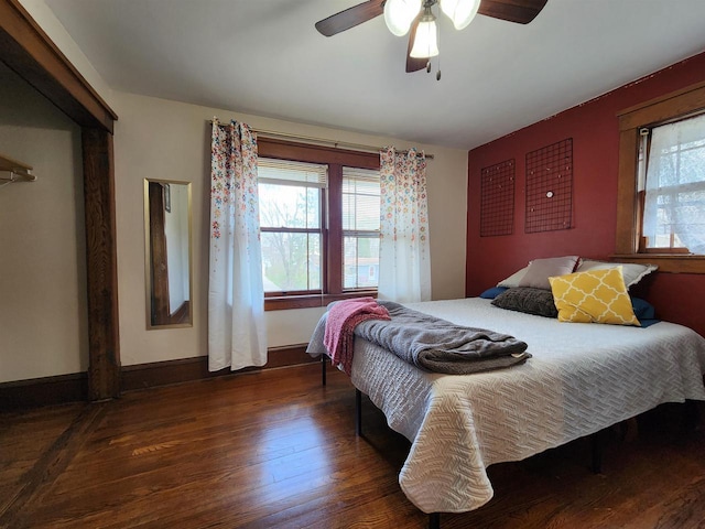 bedroom featuring baseboards, a ceiling fan, and hardwood / wood-style flooring