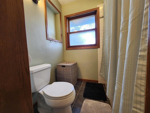 bathroom featuring tile patterned floors, toilet, and a shower with curtain