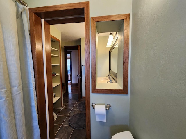 full bath featuring tile patterned floors and toilet
