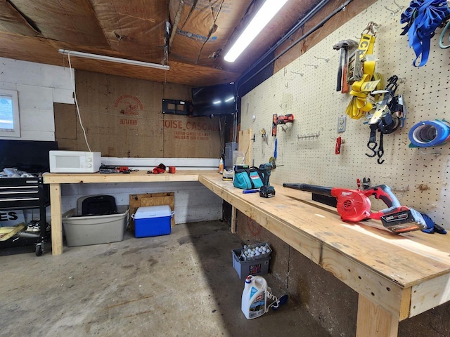 interior space with unfinished concrete floors and a workshop area