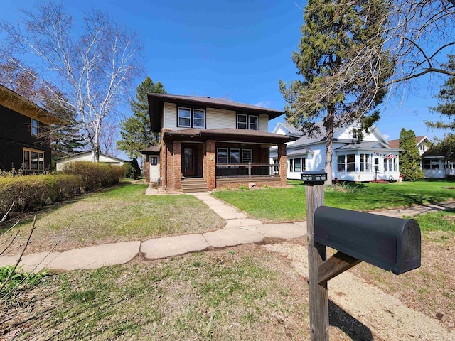 back of house featuring a yard and brick siding