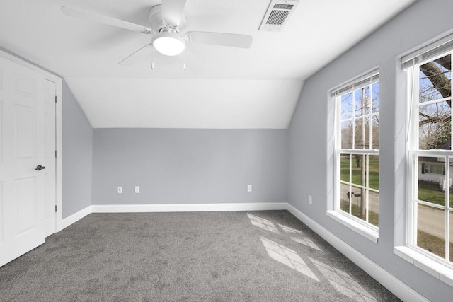 bonus room with a ceiling fan, visible vents, vaulted ceiling, baseboards, and carpet