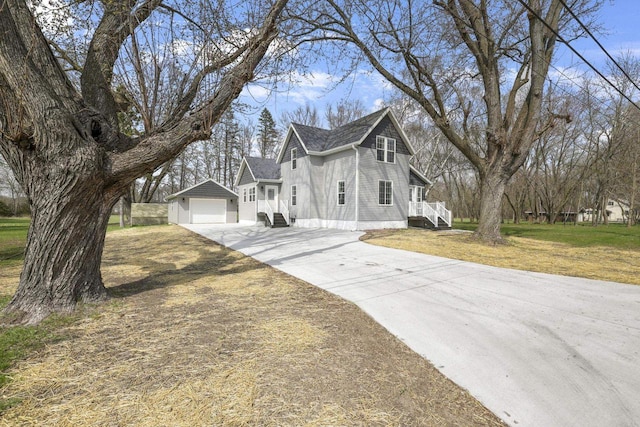 view of property exterior with a lawn, an outdoor structure, and driveway