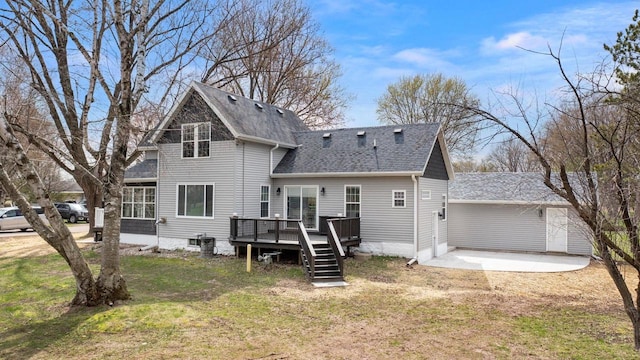 back of property featuring roof with shingles, a lawn, a deck, a patio area, and stairway