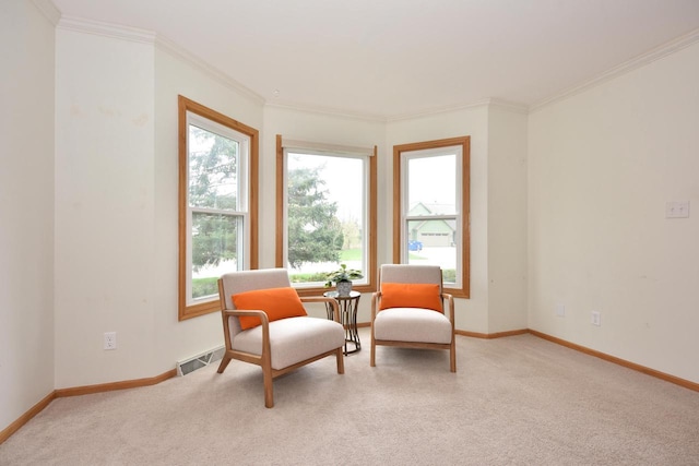 living area with crown molding, baseboards, visible vents, and light carpet