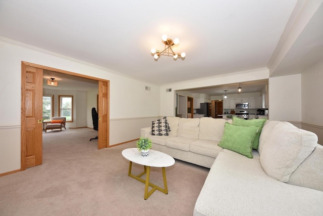 living area with crown molding, baseboards, an inviting chandelier, and light carpet