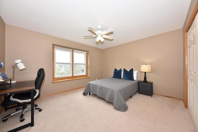 bedroom featuring baseboards, a ceiling fan, carpet, and a closet