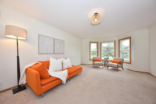 living room with crown molding, baseboards, and light colored carpet