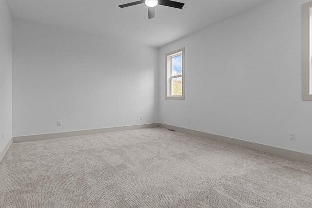 N9046 Southtowne Dr, Menasha, WI 54952 - empty room with baseboards, carpet, and a ceiling fan