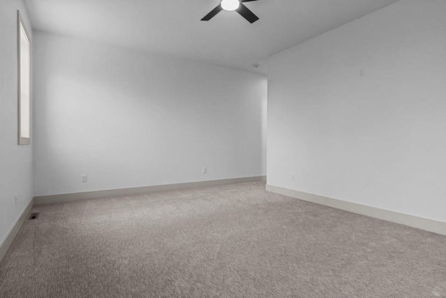 N9046 Southtowne Dr, Menasha, WI 54952 - spare room with baseboards, ceiling fan, carpet, and visible vents