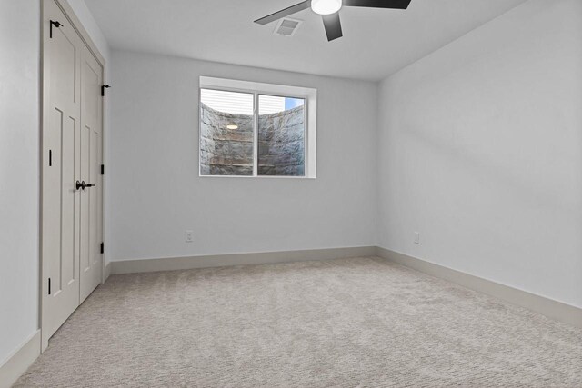 N9046 Southtowne Dr, Menasha, WI 54952 - unfurnished bedroom with baseboards, visible vents, a ceiling fan, and light colored carpet