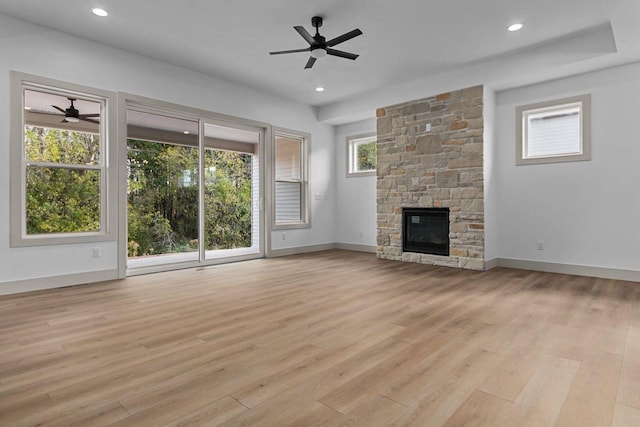 N9046 Southtowne Dr, Menasha, WI 54952 - unfurnished living room featuring baseboards, a ceiling fan, and light wood finished floors