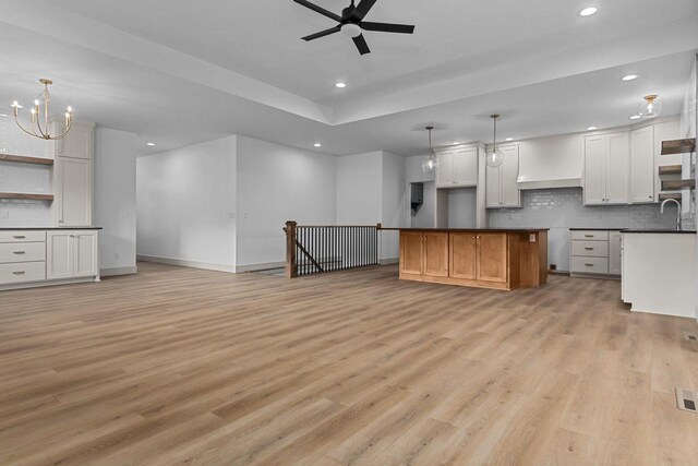 N9046 Southtowne Dr, Menasha, WI 54952 - kitchen with tasteful backsplash, light wood finished floors, ceiling fan with notable chandelier, and recessed lighting