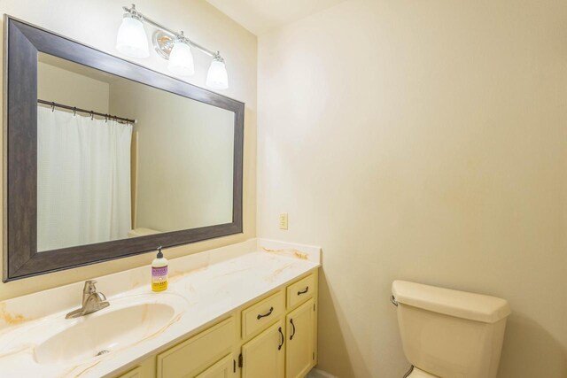 full bath featuring toilet and vanity