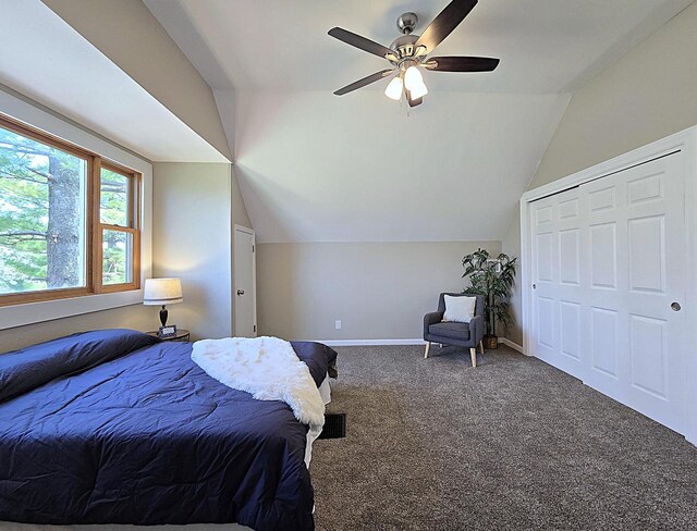 carpeted bedroom featuring baseboards, ceiling fan, and vaulted ceiling
