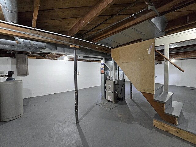 unfinished below grade area with heating unit and stairs
