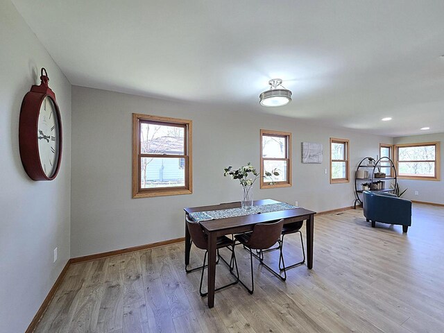 dining space with recessed lighting, baseboards, and light wood finished floors