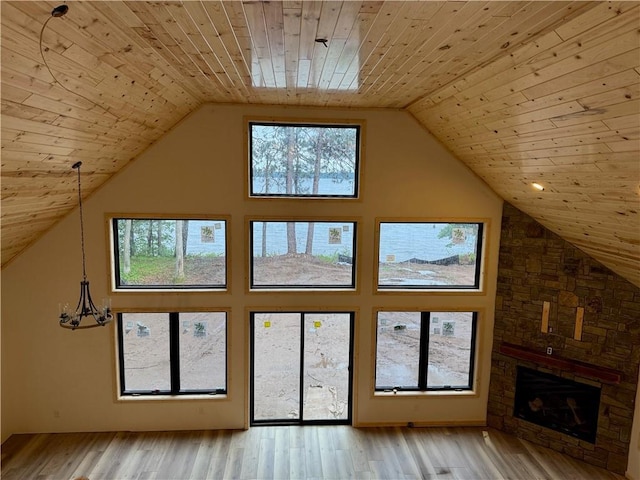 6069 Elsie Rd, Stone Lake, WI 54876 - additional living space with wood ceiling, high vaulted ceiling, light wood-style floors, and a fireplace