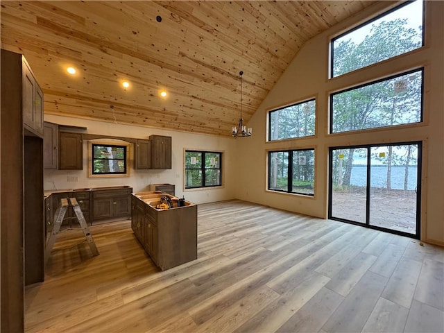 6069 Elsie Rd, Stone Lake, WI 54876 - kitchen with high vaulted ceiling, wooden ceiling, light wood-style floors, a chandelier, and open floor plan