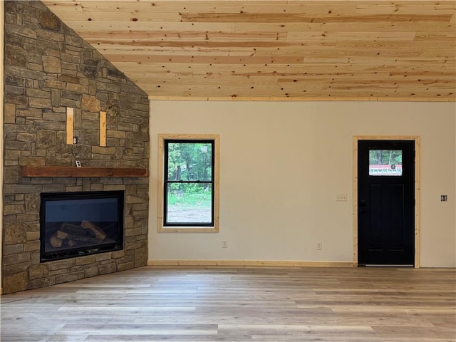6069 Elsie Rd, Stone Lake, WI 54876 - unfurnished living room with wood ceiling, vaulted ceiling, wood finished floors, and a stone fireplace