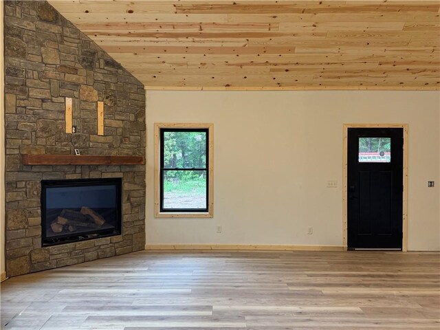 6069 Elsie Rd, Stone Lake, WI 54876 - unfurnished living room featuring wood ceiling, vaulted ceiling, wood finished floors, and a stone fireplace