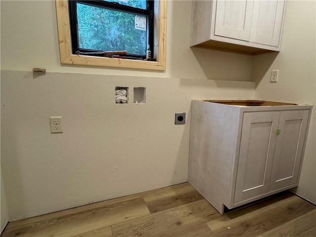 6069 Elsie Rd, Stone Lake, WI 54876 - laundry area with hookup for an electric dryer, wood finished floors, and cabinet space