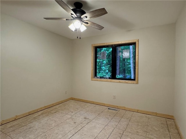 6069 Elsie Rd, Stone Lake, WI 54876 - spare room featuring baseboards and a ceiling fan