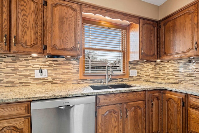 kitchen featuring a sink, tasteful backsplash, brown cabinetry, and dishwasher