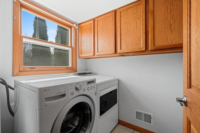 laundry room with visible vents, cabinet space, and washing machine and dryer