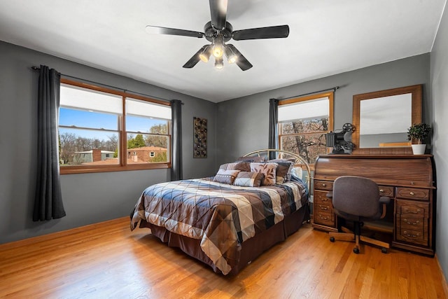 bedroom with light wood-style floors and a ceiling fan