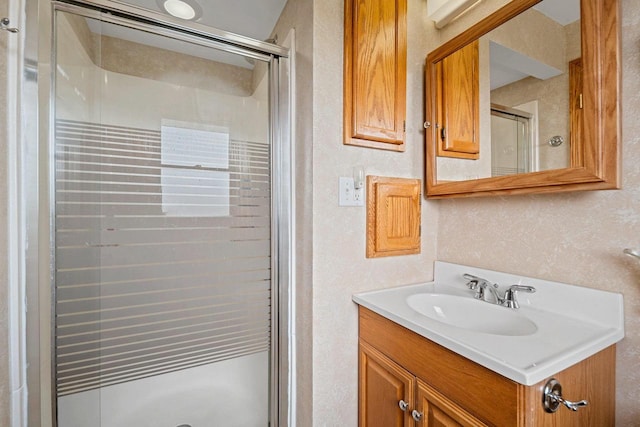 bathroom featuring vanity and a stall shower
