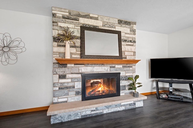 interior details featuring baseboards, wood finished floors, and a fireplace