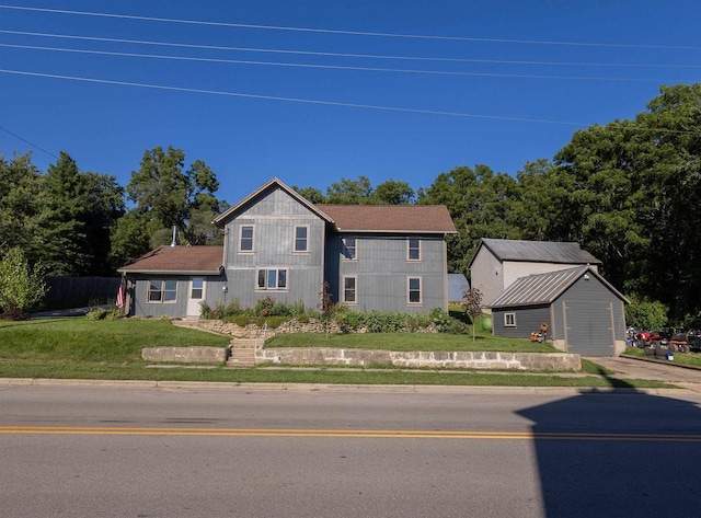 1694 Washington St, Verona, WI 53593 - view of front of house featuring an outdoor structure and a front lawn