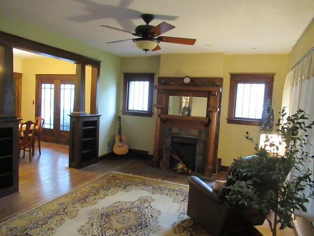 321 E Centerway, Janesville, WI 53545 - living area featuring a healthy amount of sunlight, a fireplace with flush hearth, ceiling fan, and wood finished floors