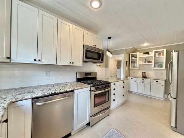 852 Sherwood Dr NW, Beloit, WI 53511 - kitchen featuring white cabinets, light stone countertops, stainless steel appliances, light tile patterned floors, and backsplash