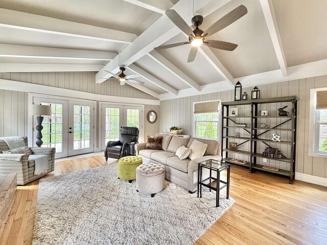 852 Sherwood Dr NW, Beloit, WI 53511 - living room featuring light wood-style floors, vaulted ceiling with beams, a ceiling fan, and french doors