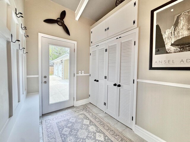 852 Sherwood Dr NW, Beloit, WI 53511 - doorway featuring vaulted ceiling with beams, marble finish floor, and ceiling fan