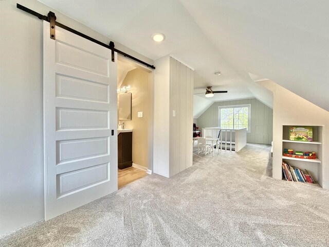852 Sherwood Dr NW, Beloit, WI 53511 - interior space with carpet floors, ceiling fan, a barn door, and lofted ceiling