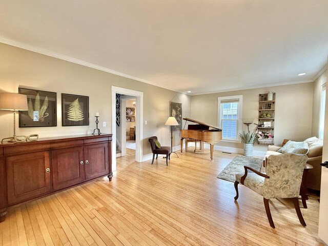 852 Sherwood Dr NW, Beloit, WI 53511 - living area featuring light wood-style floors, baseboards, and ornamental molding