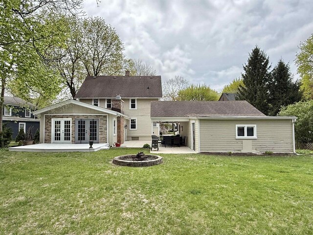 852 Sherwood Dr NW, Beloit, WI 53511 - back of house with a patio, a yard, french doors, and a chimney